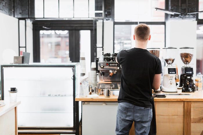 coffee shop with barman making coffee