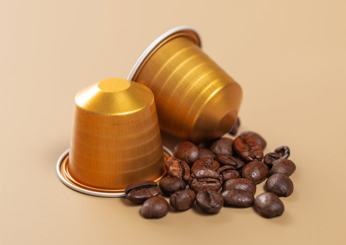 capsules-with-coffee-drink-raw-fresh-beans-beige-background