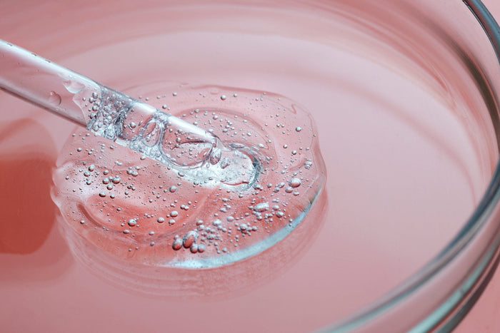 Close-up of a clear collagen peptides with air bubbles and dropper