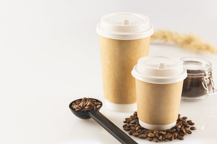 2 plastic coffee cups with some coffee beans 