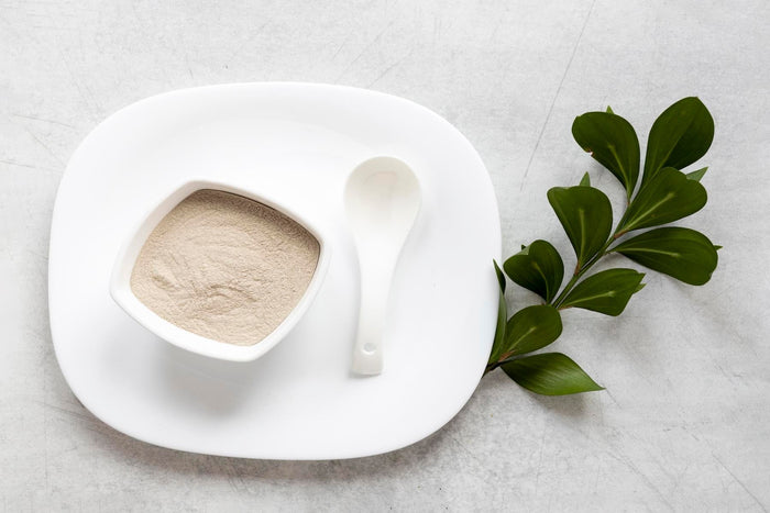 Organic maca root powder in a white ceramic bowl on a clean surface