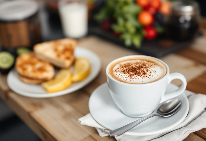 Cup-of-coffee-with-a-healthy-breakfast-featuring-toast-lemon-slices-and-fresh-vegetables-in-the-background