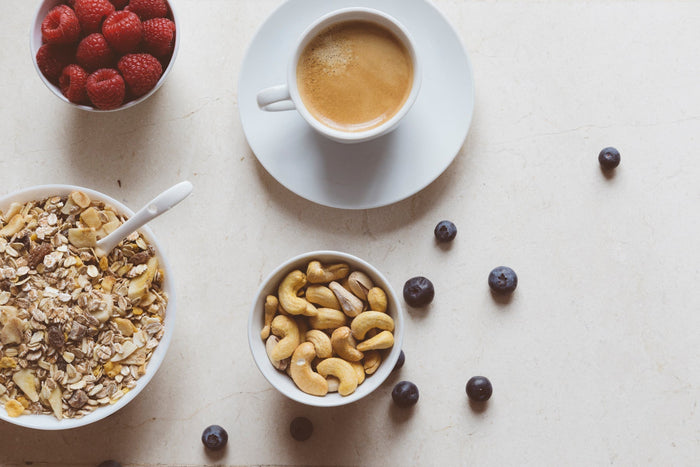  fresh berries, cashews, hearty muesli, and a hot cup of coffee.
