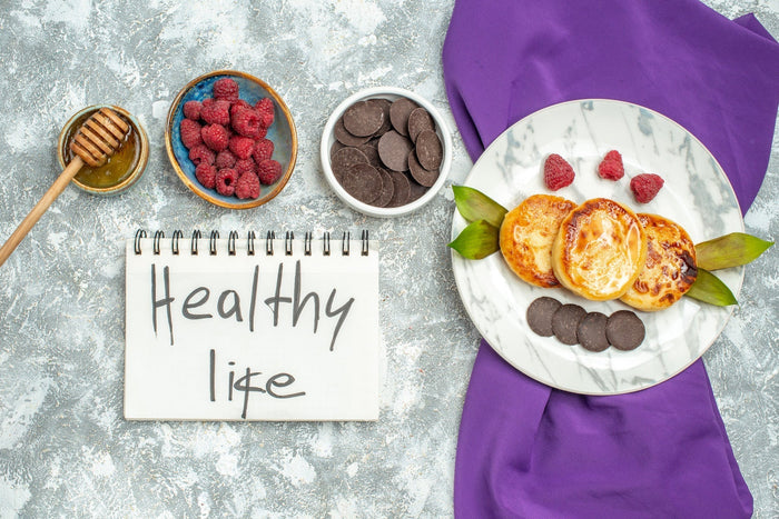top view delicious muffins with choco biscuits raspberries light background